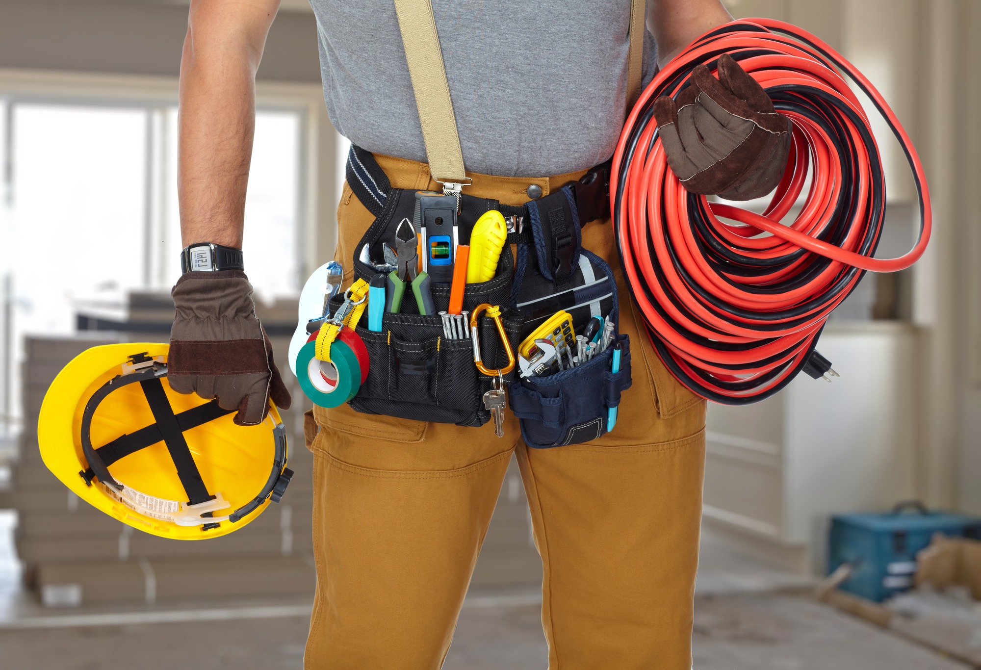 Electrician with tools and cable.